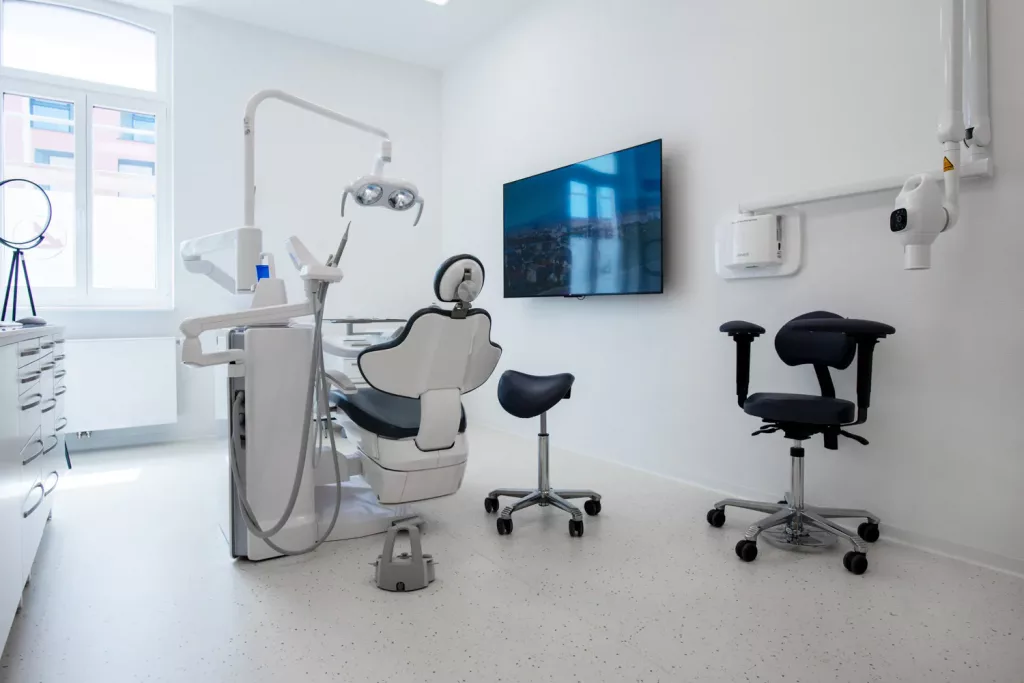 Loepraxis Dr Wilamowskiweb048 Dr Matthias Willamowski Kollegen Modern dental clinic with a white treatment chair overhead light and attached equipment in a bright room